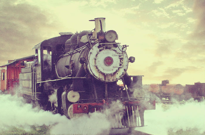 steam locomotive with cloudy sky backdound